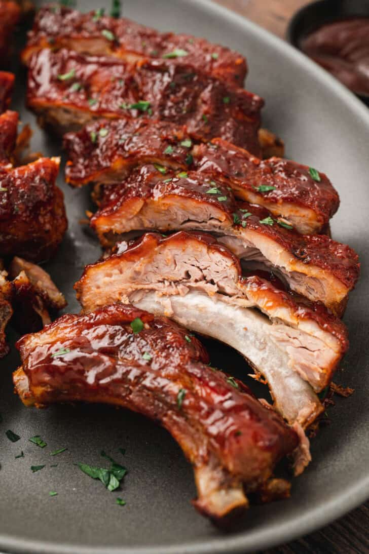 Cooked pork meat on the bone, covered with barbecue sauce.
