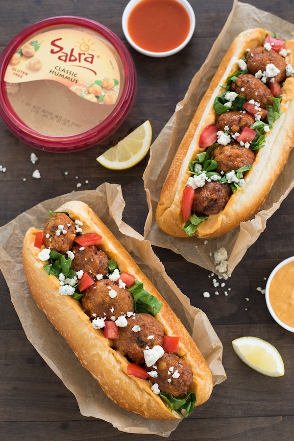 Buffalo Falafel Subs - Fried chickepea fritters are tossed in buffalo sauce then piled into subs with buffalo-flavored hummus, lettuce, tomato and blue cheese! | foxeslovelemons.com