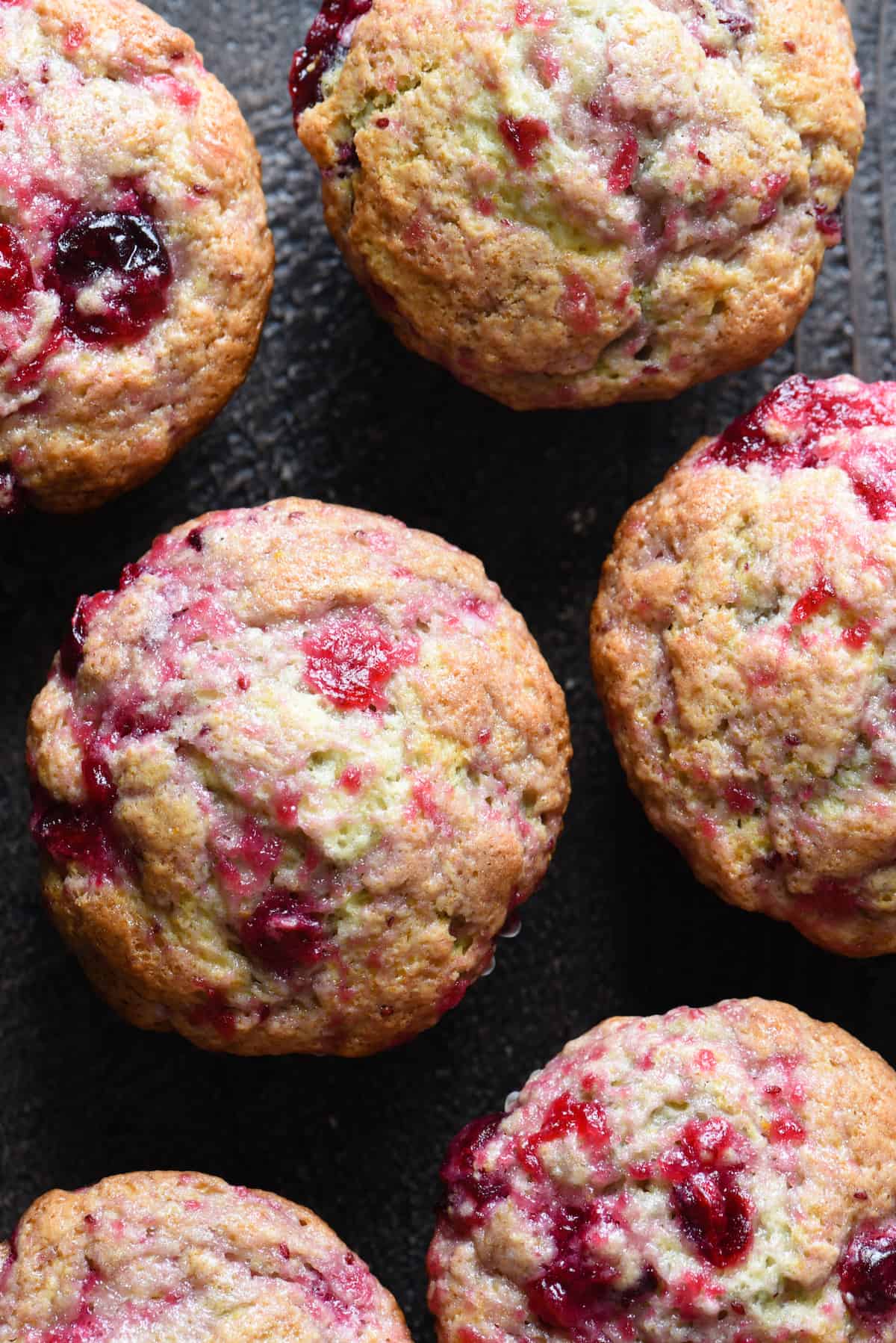 Overhead photo of six cranberry sauce muffins.