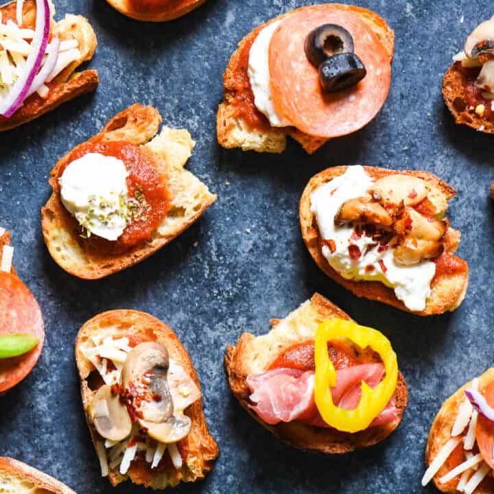Crostini pizzas made from toasted baguette slices topped with tomato sauce, cheese and a variety of meat and vegetable toppings.