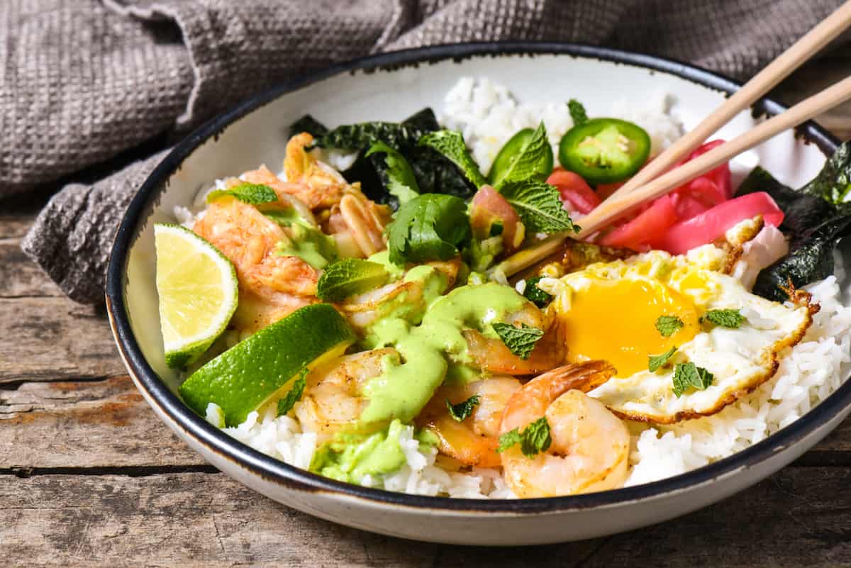 Funky Good Rice & Shrimp Bowls - Shake up your weeknight dinner routine with a rice bowl loaded with shrimp, pickled veggies and a fried egg, and topped with an easy homemade green chili sauce. | foxeslovelemons.com