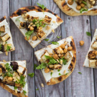 Grilled Eggplant Flatbread - A lovely vegetarian meal or party bite that comes together in a flash. Grilled naan bread is spread with creamy Greek yogurt and topped with grilled eggplant, spiced chickpeas and pine nuts. | foxeslovelemons.com