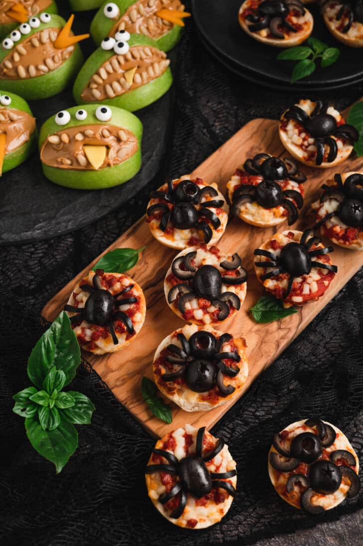 Halloween food ideas like spider pizzas and apple monsters.
