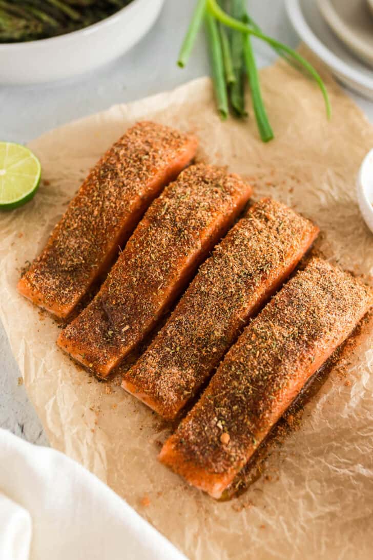 Four fillets of fish rubbed with blackened salmon seasoning.