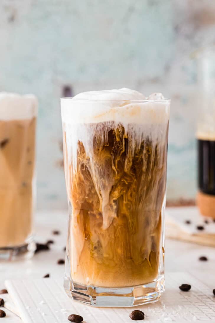 A large glass of salted caramel cream cold brew coffee.