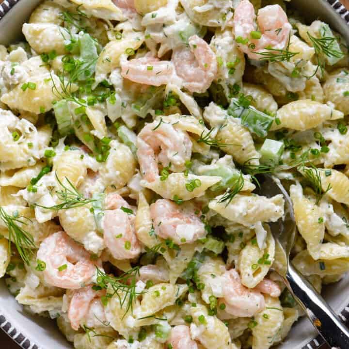 Serving bowl filled with shrimp and crab pasta salad.