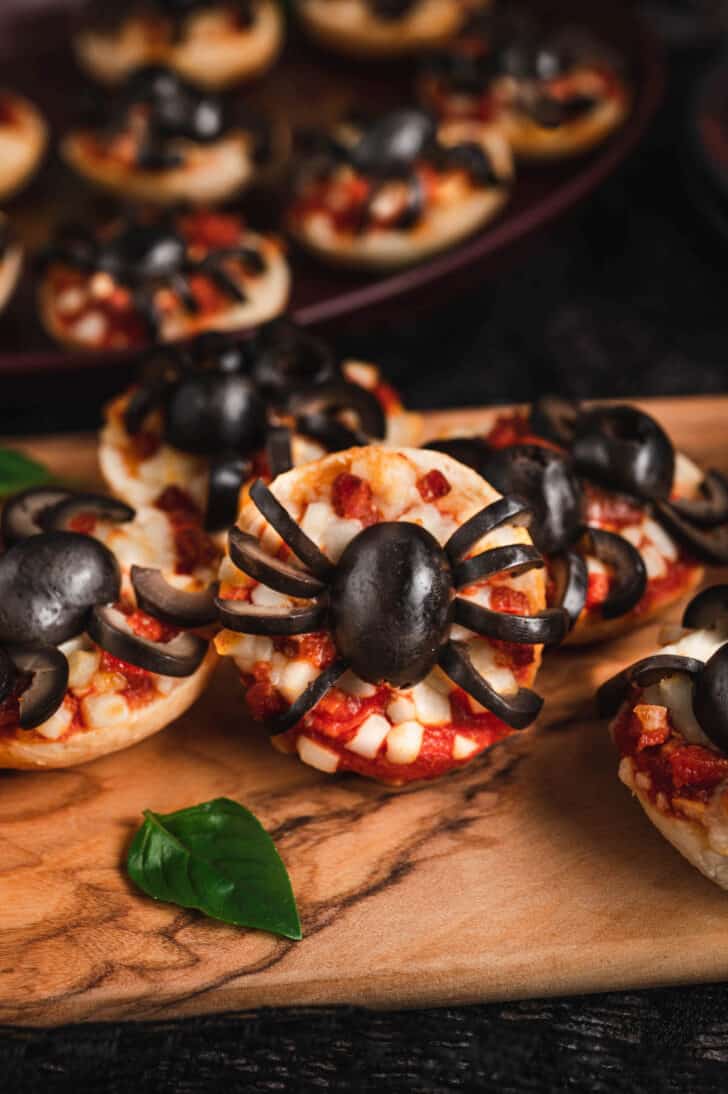 A mini pizza decorated with a black olive cut to look like a spider.