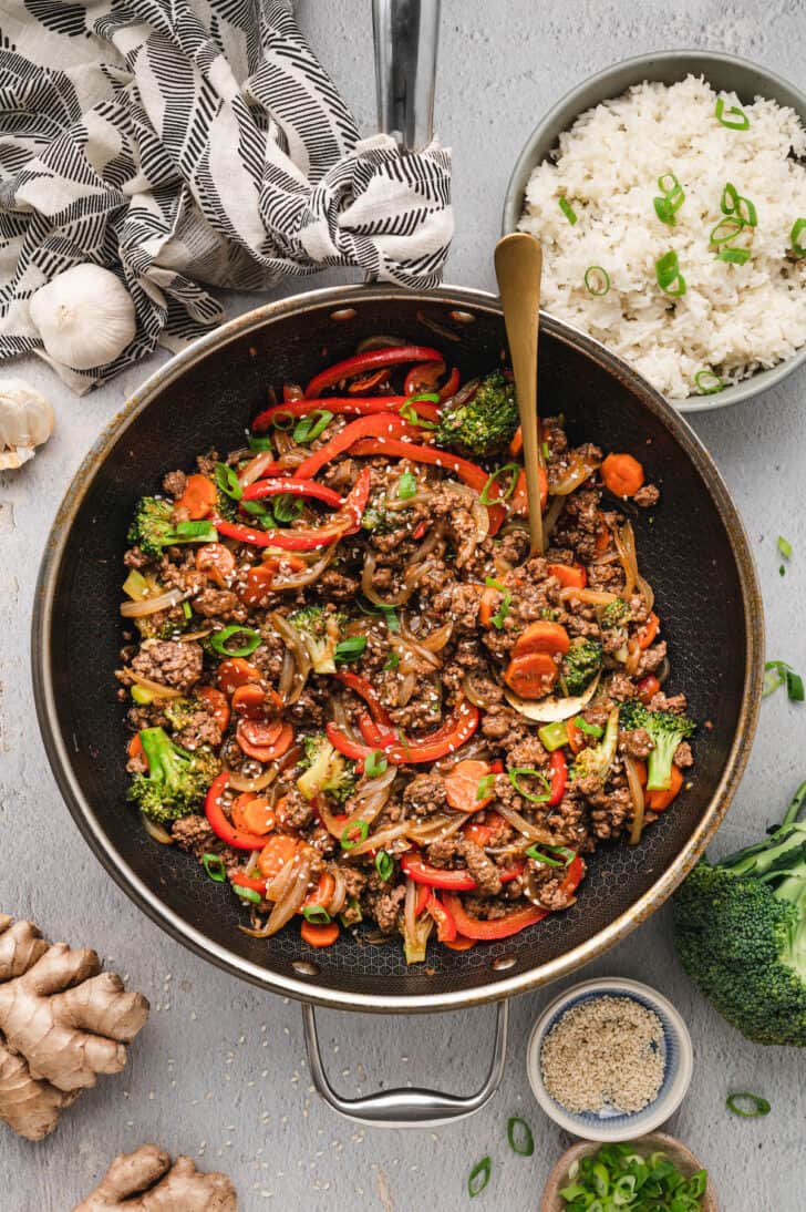 A large skillet filled with stir fry ground beef and vegetables.