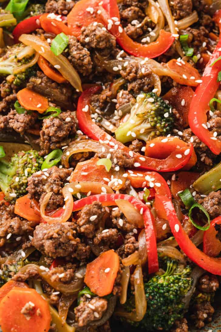 Closeup on a stir fry ground beef recipe garnished with sesame seeds.