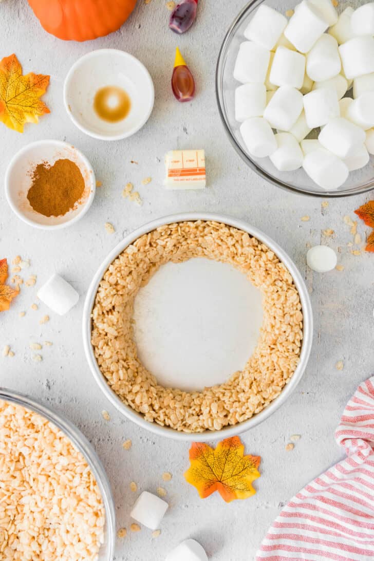 A ring of rice cereal dessert pressed into the outside edge of a round cake pan.