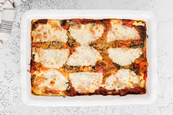 A vegetable lasagna in a white baking dish.
